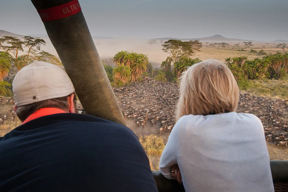 Guests viewing the Great Migration from a hot air balloon over the Serengeti