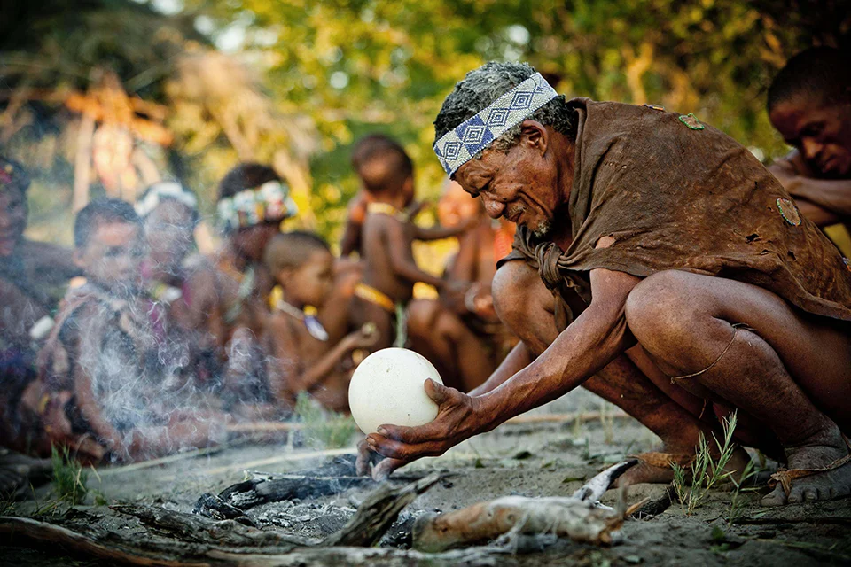 San guide demonstrating traditional bush skills during a cultural experience near Camp Kalahari, Makgadikgadi